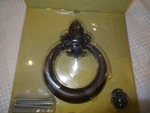 Atlas D636-O Fleur D'lys Door Knocker In Aged Bronze-open. Fixed Price $69.00.